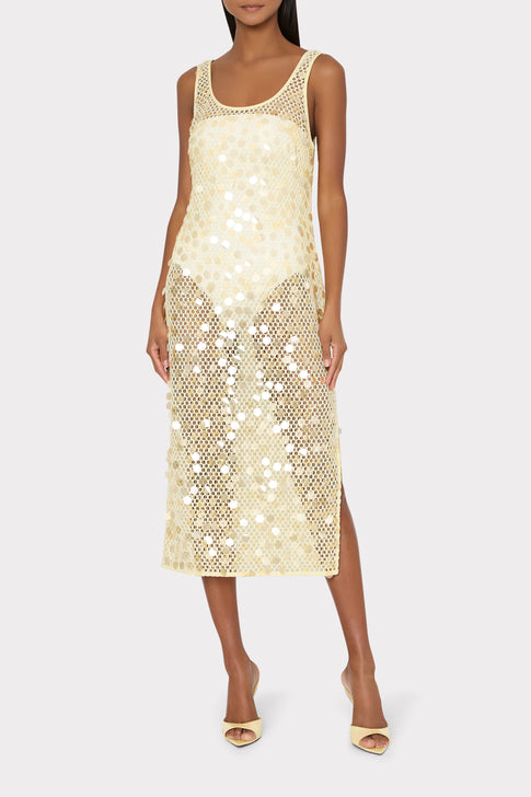 Woman wearing a light yellow sequin crochet cover-up dress on a white background